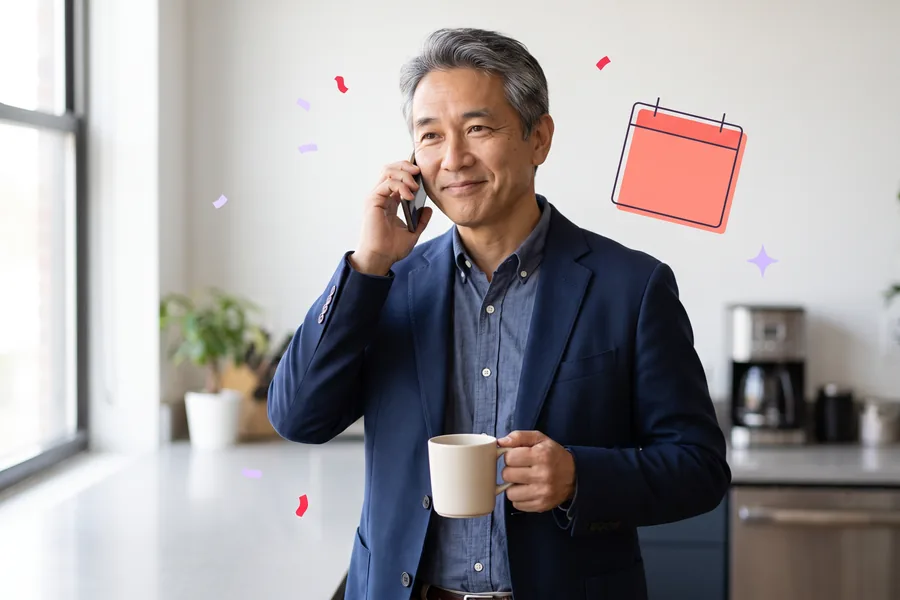 Client services lead in an office kitchen on a phone call, mug in hand