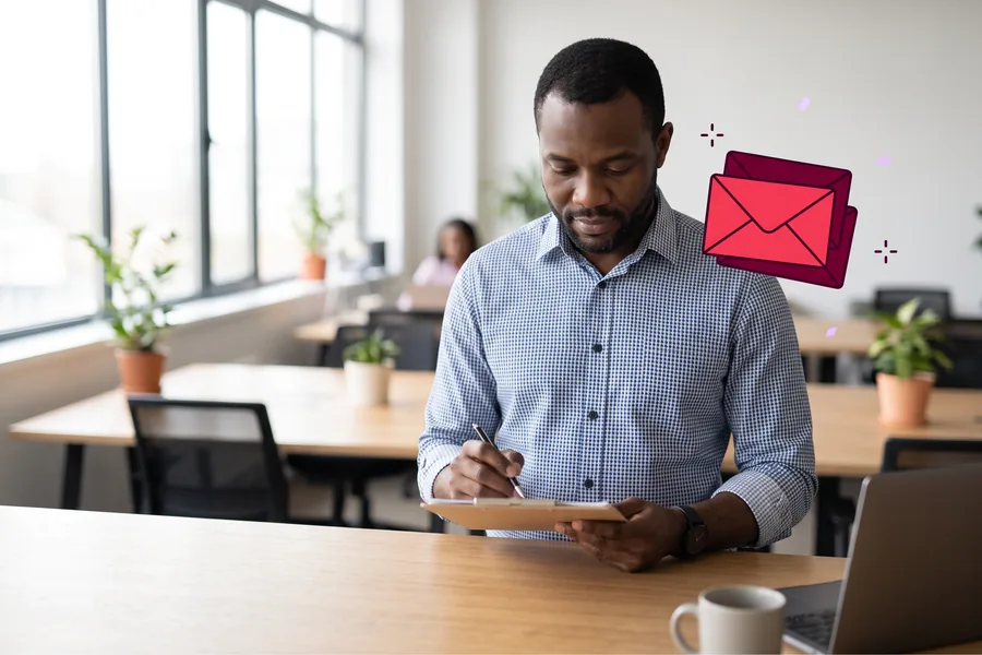Man in an office reviewing a participant roster on a clipboard