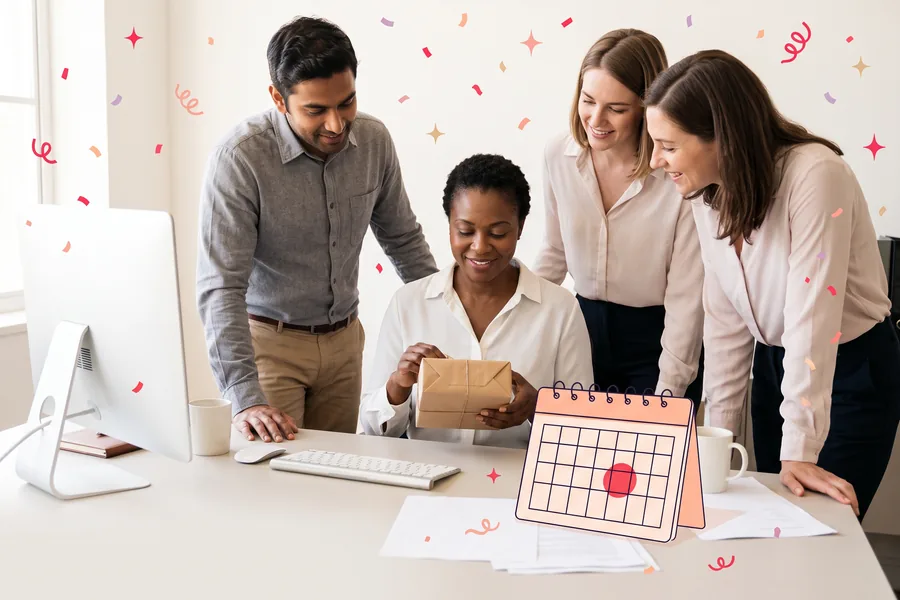 Colleagues gathered around a coworker at her desk as she opens a small wrapped gift