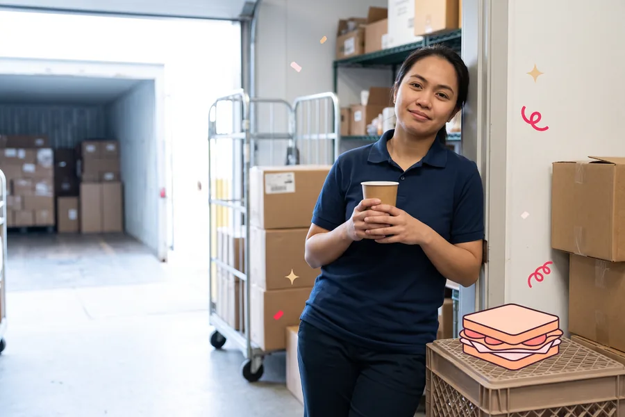 Retail associate on a short break in the stockroom doorway with a cup of coffee