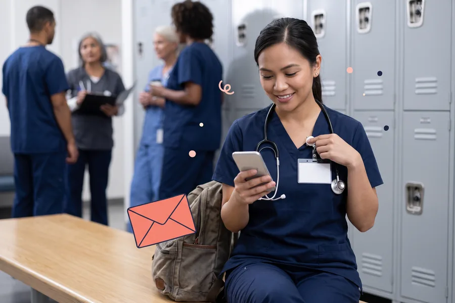 Nurse clipping on her badge in a hospital locker room, checking her phone