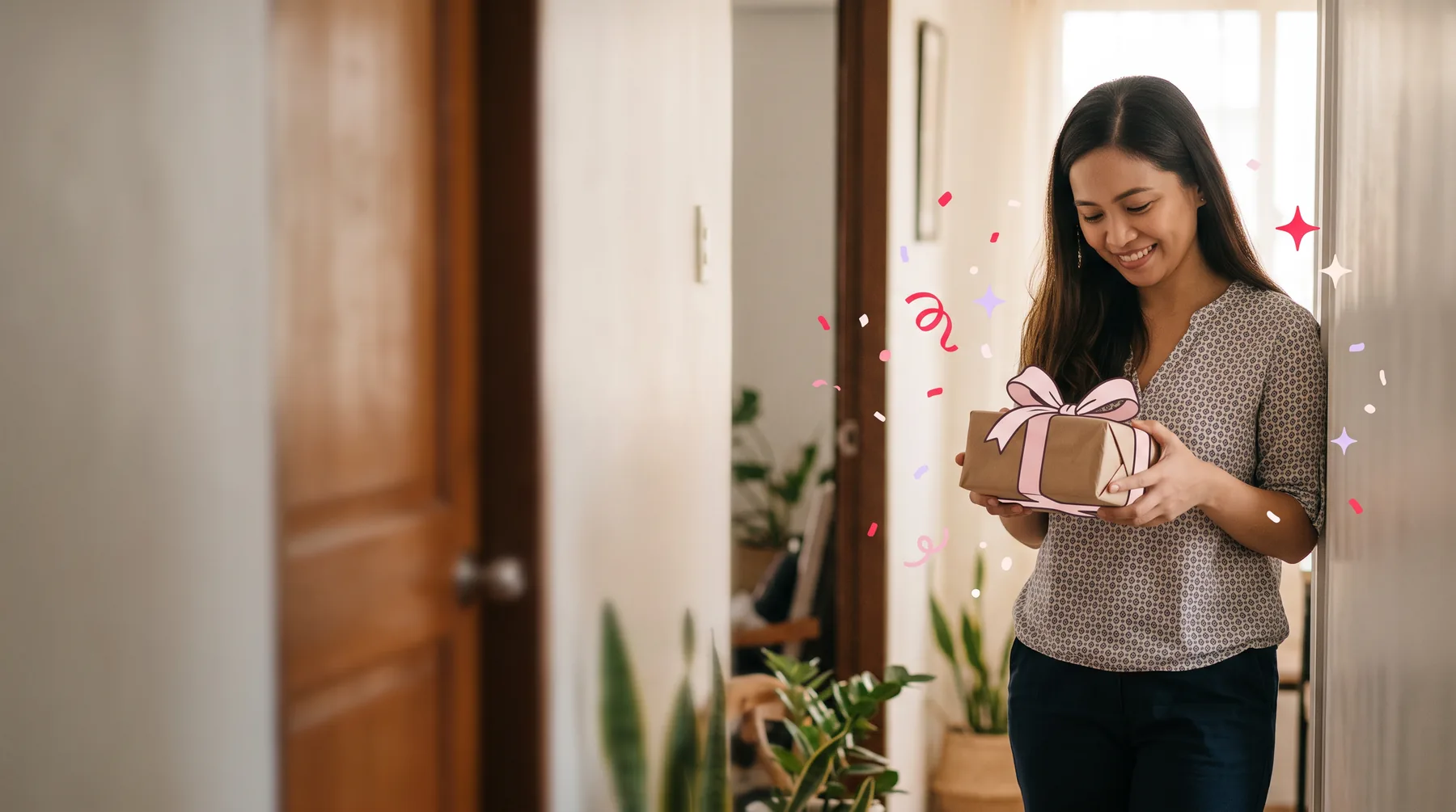 Woman in an apartment doorway holding a small parcel just handed to her