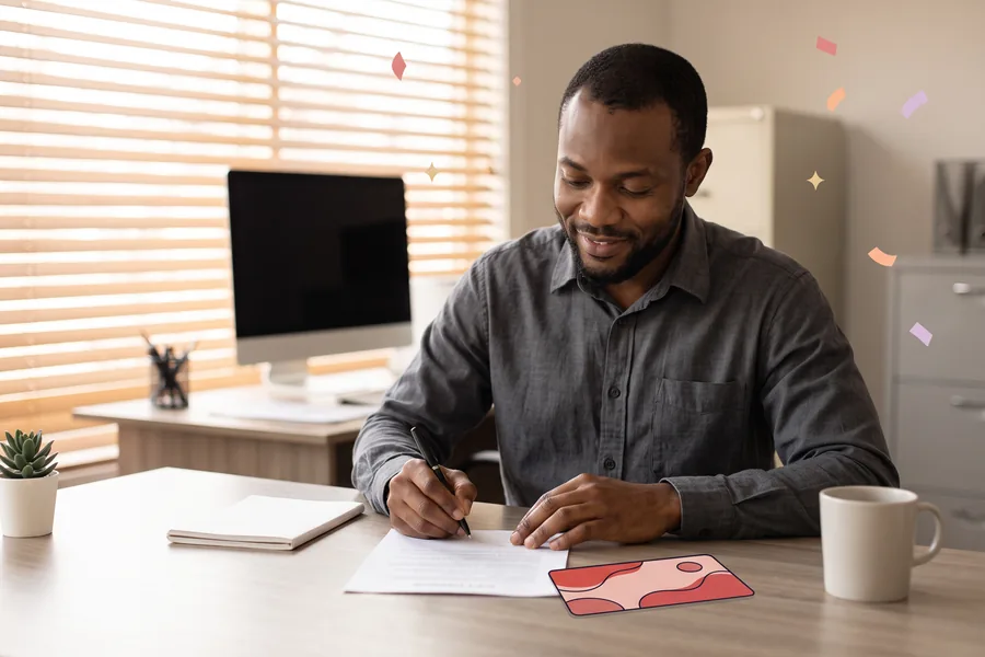 Tenant signing a lease renewal at a leasing office desk