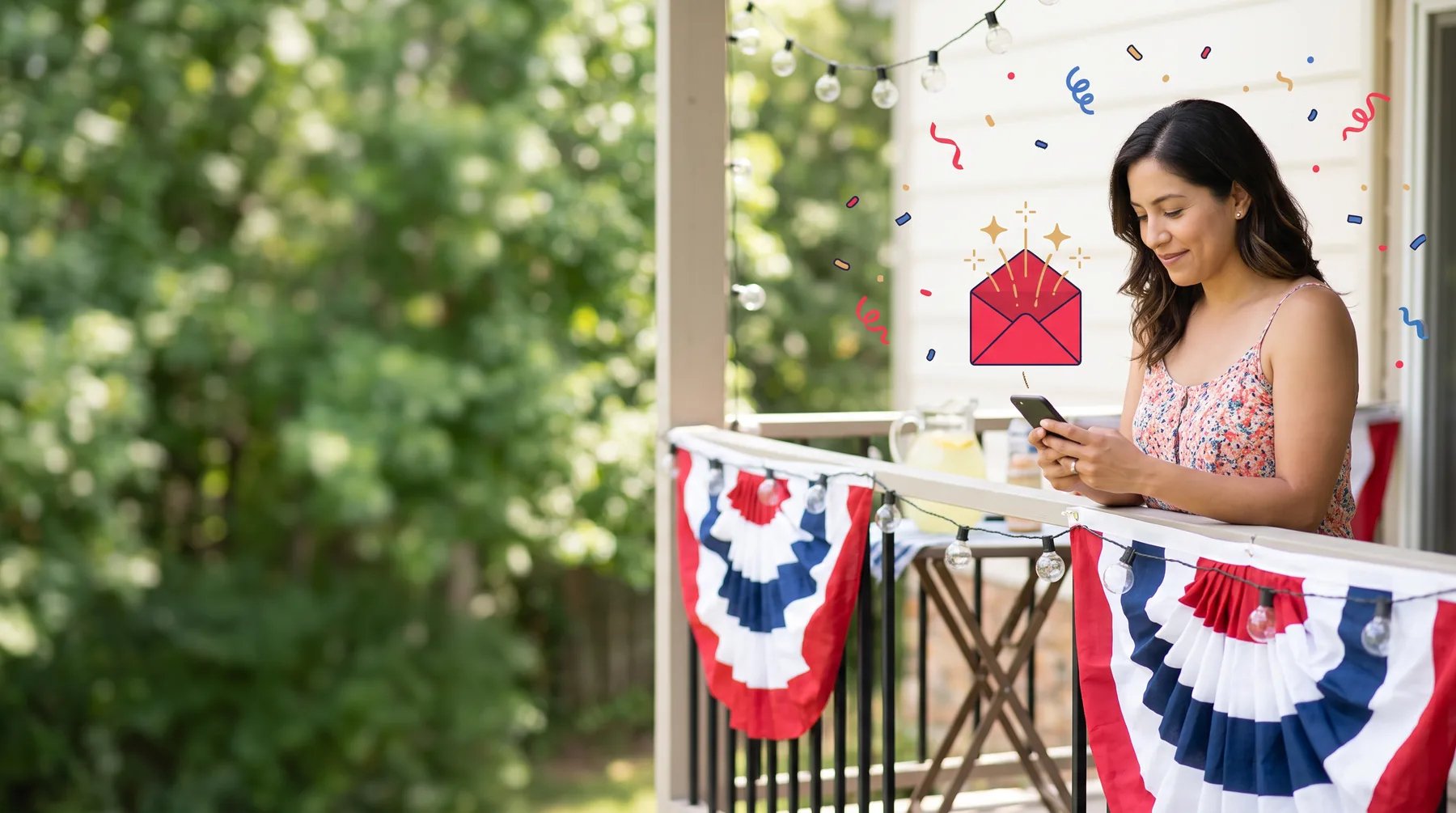 Woman on a balcony strung with red, white and blue bunting, smiling at her phone