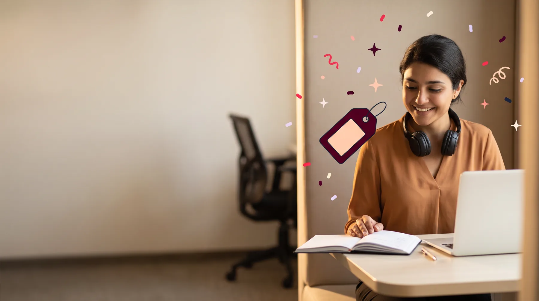 Researcher in an office booth with headphones around her neck after a remote interview