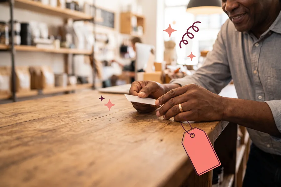 Hands sliding a gift card across a wooden shop counter