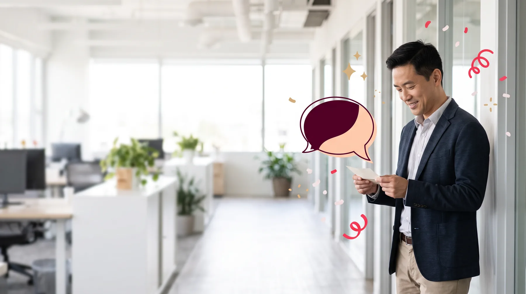 Man in an office corridor smiling as he reads a note from a colleague