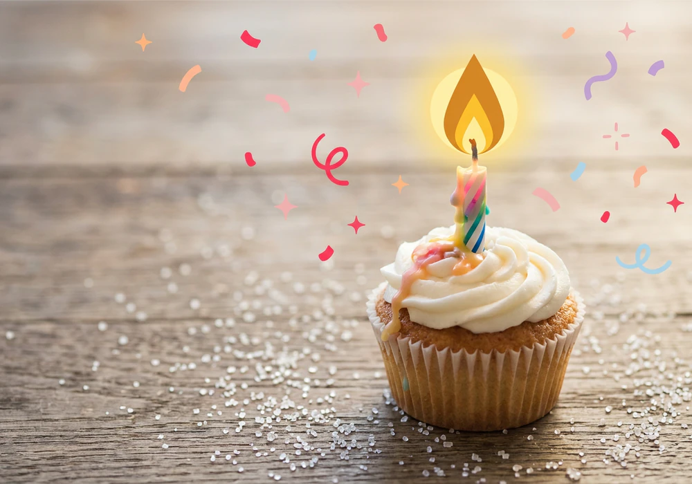 A birthday cake with one candle, an illustrated wish floating above it