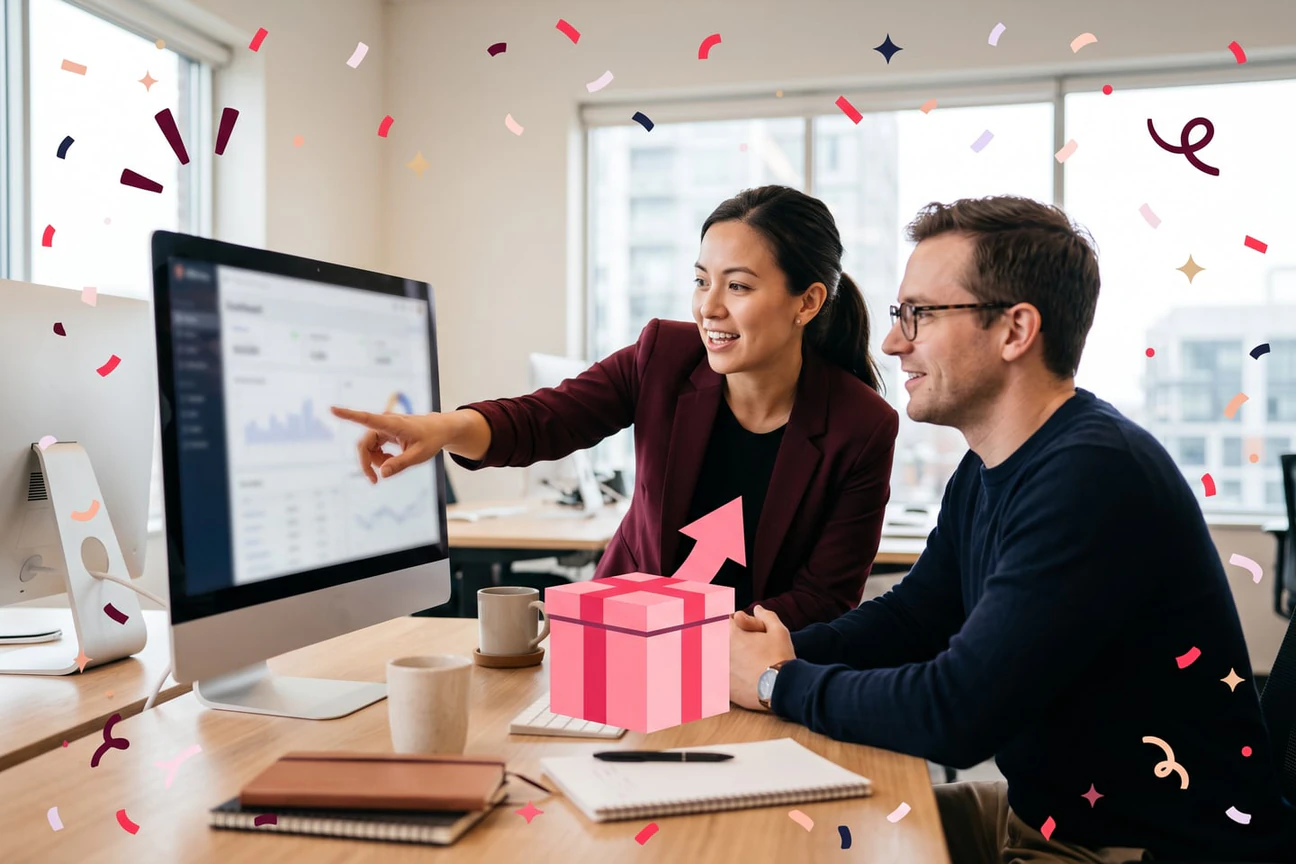 Two colleagues reviewing a recognition dashboard together in a bright office