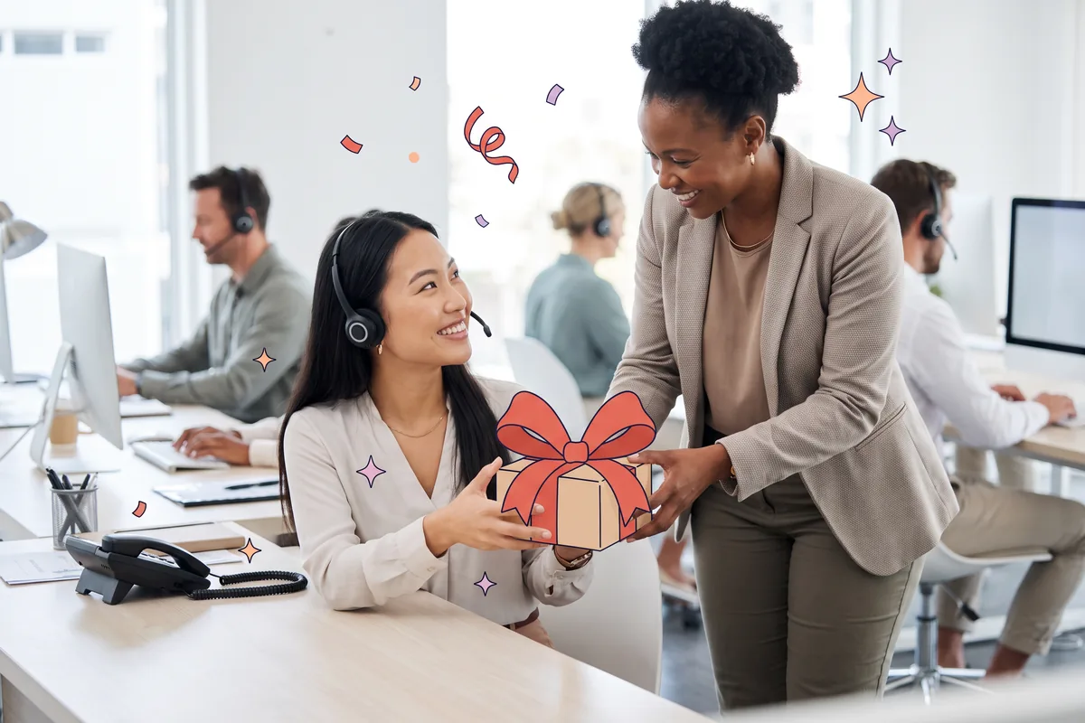 Team lead handing a wrapped gift to a call center agent wearing a headset